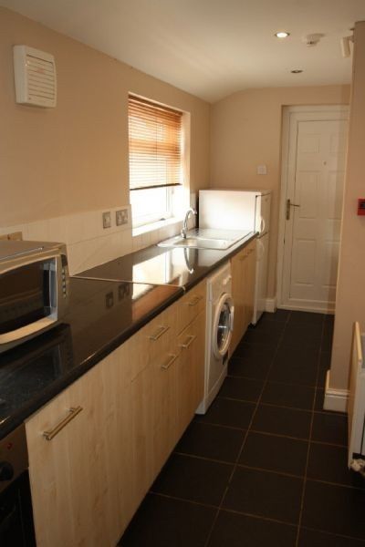 Property photo 1 of 6 Well-Presented Galley Kitchen With Sleek Dark Coun...