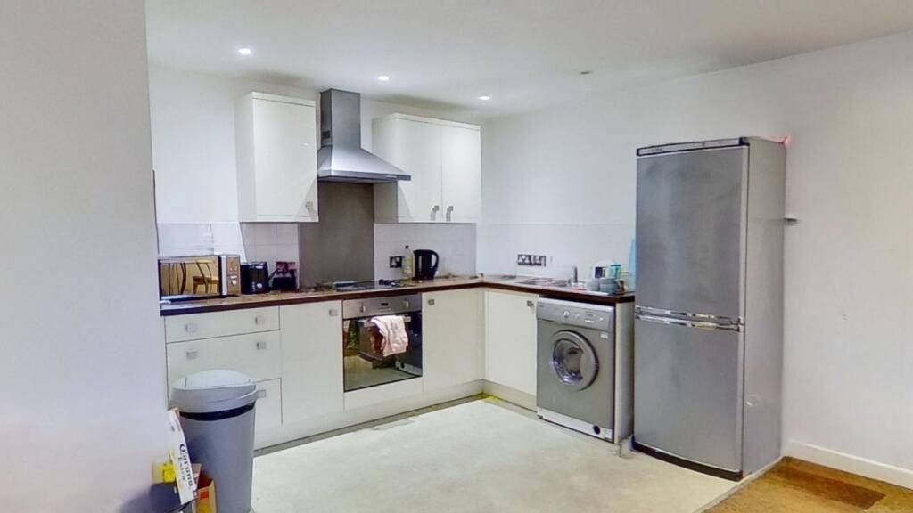 Property photo 3 of 5 Bright And Modern Kitchen Featuring White Cabinetr...
