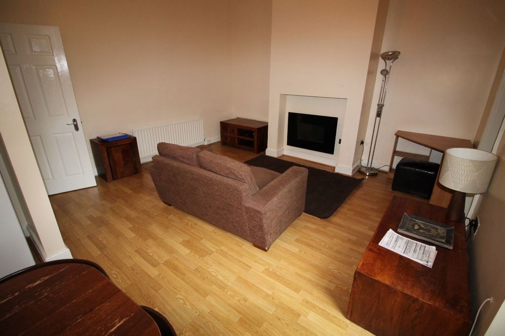Property photo 1 of 10 A Cozy Living Room Featuring A Stylish Sofa And Ta...
