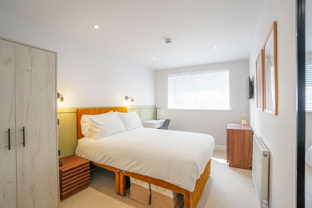 Property photo 2 of 15 Bright And Inviting Master Bedroom Featuring A Com...
