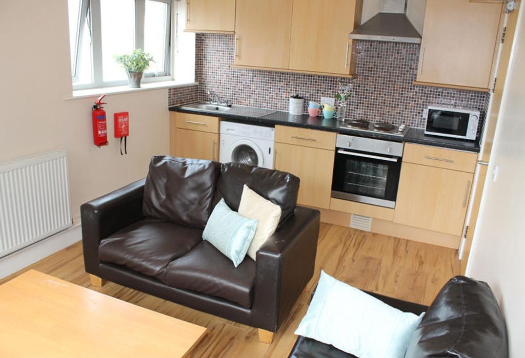 Property photo 3 of 7 This Modern Kitchen Boasts Ample Storage With Slee...