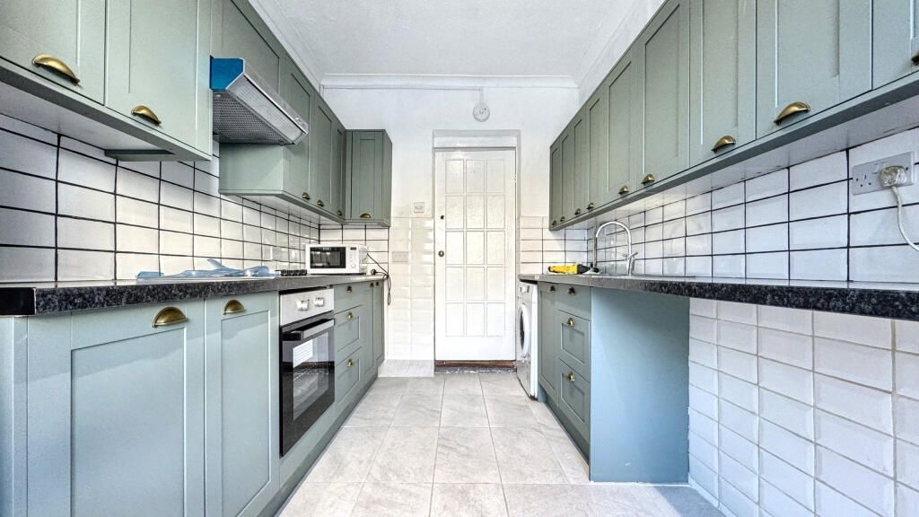Property photo 1 of 13 Bright And Modern Kitchen Featuring Sleek Cabinetr...