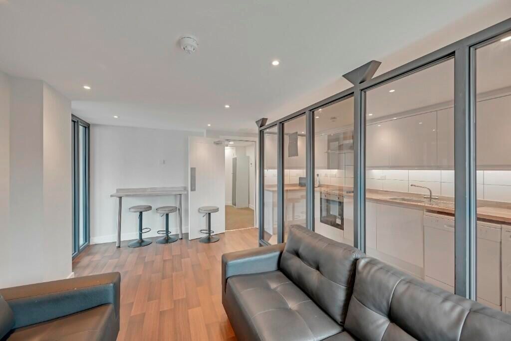 Property photo 2 of 15 A Modern Living Room Featuring Sleek Leather Sofas...
