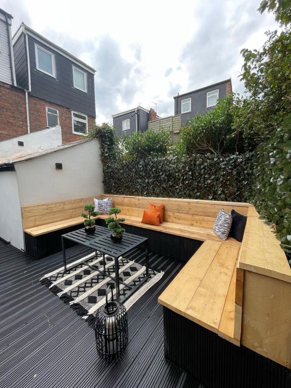 Property photo 1 of 5 A Cozy Outdoor Patio Area With Built-In Wooden Sea...