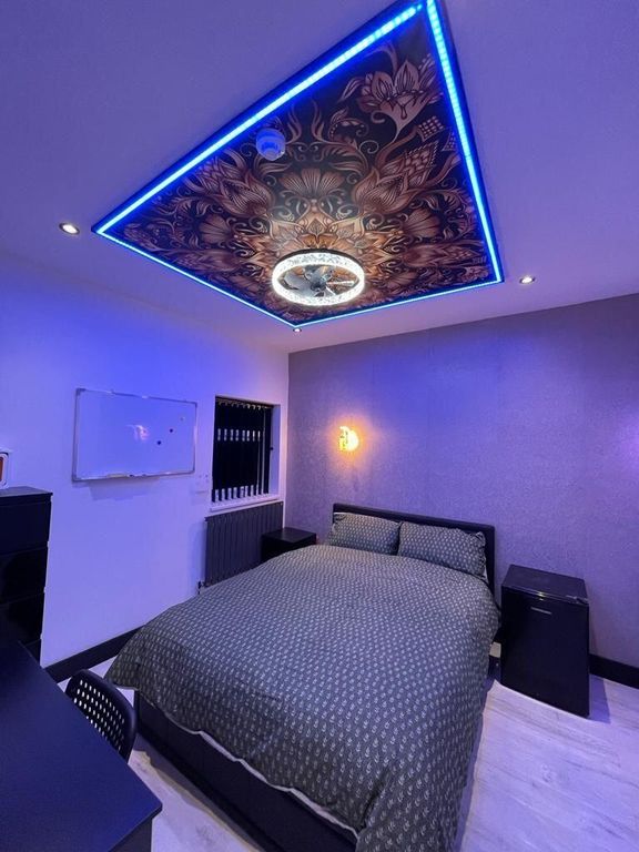 Property photo 3 of 12 A Stylish Master Bedroom Featuring A Comfortable d...