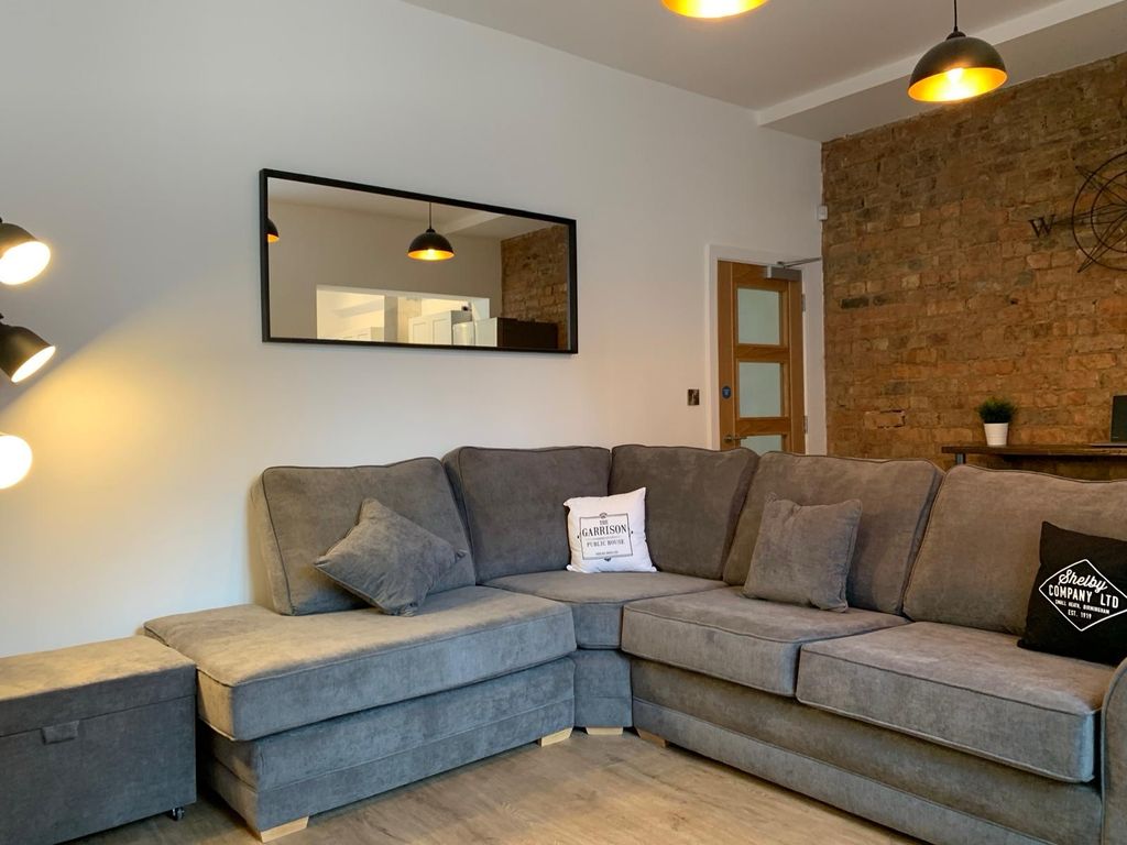 Property photo 1 of 8 Modern And Stylish Living Room Featuring A Large, ...