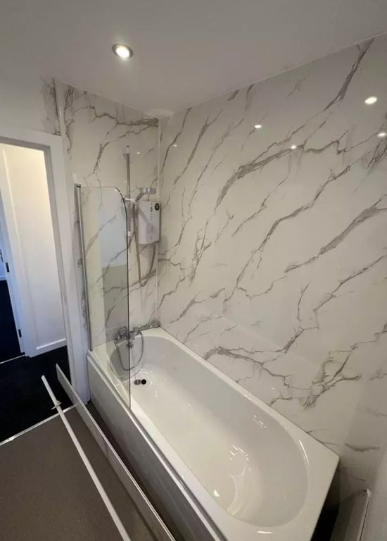 Property photo 2 of 10 A Stylish And Modern Bathroom Featuring A Luxuriou...