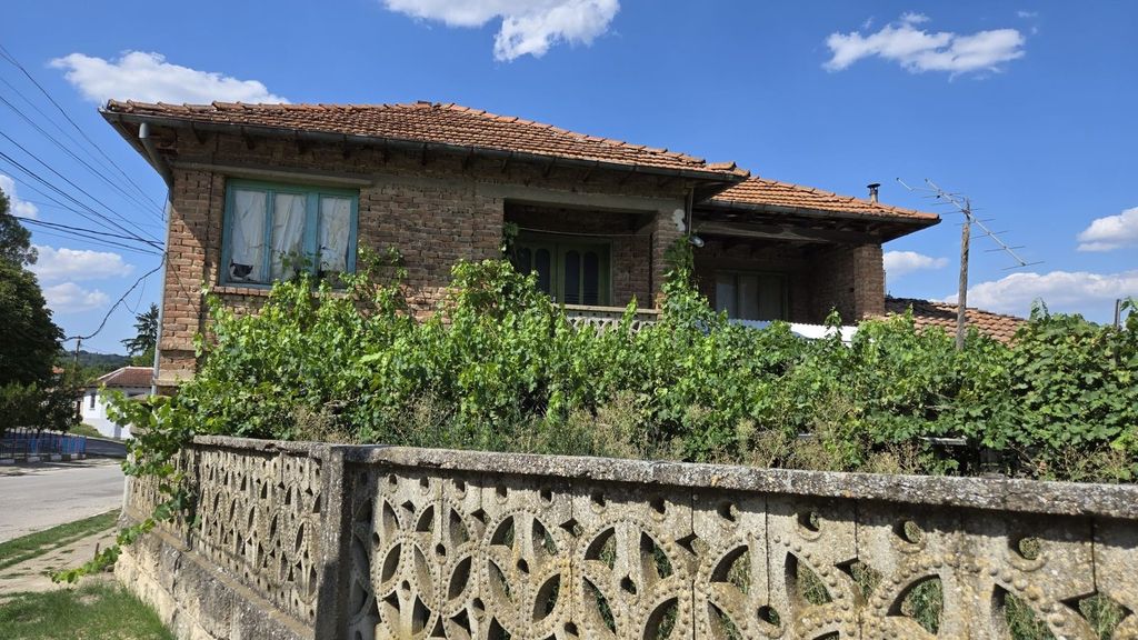 Property photo 1 of 56 Front View Of A Brick House With Green Framed Windows And Grapevines Growing Along A Decorative Concrete Fence