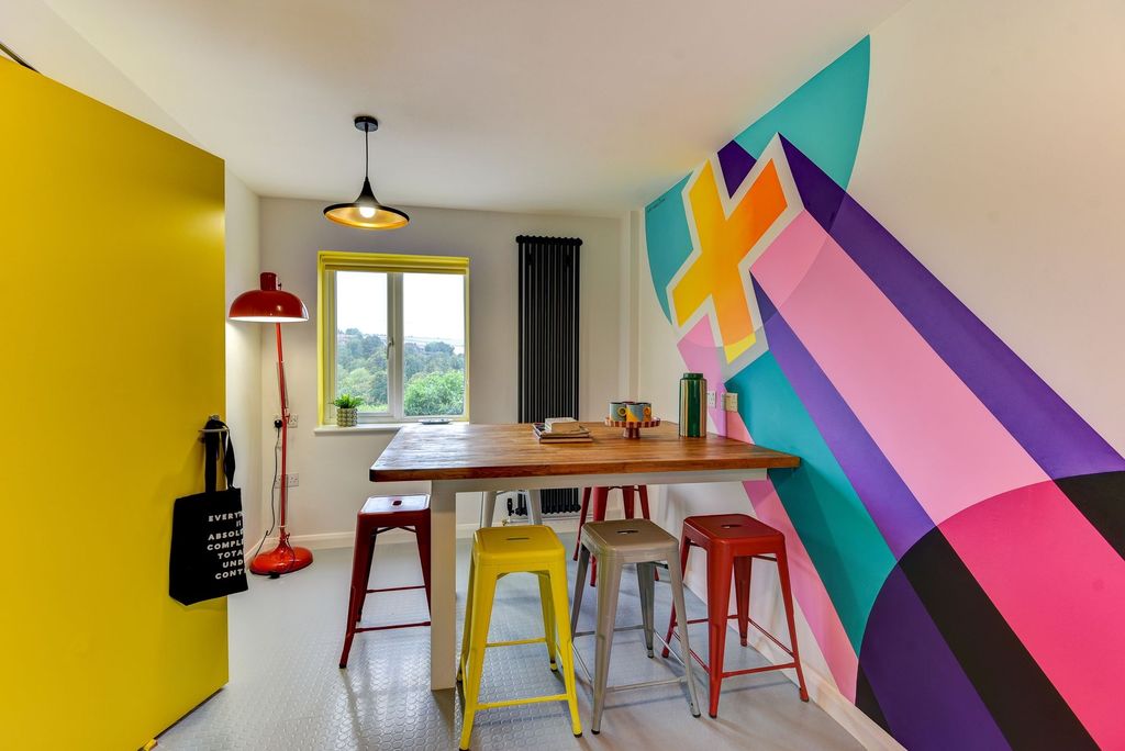Property photo 2 of 8 Bright And Colorful Communal Workspace Featuring A...