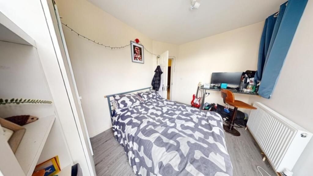Property photo 2 of 13 A Cozy Single Bedroom Featuring A Neatly Made Bed ...