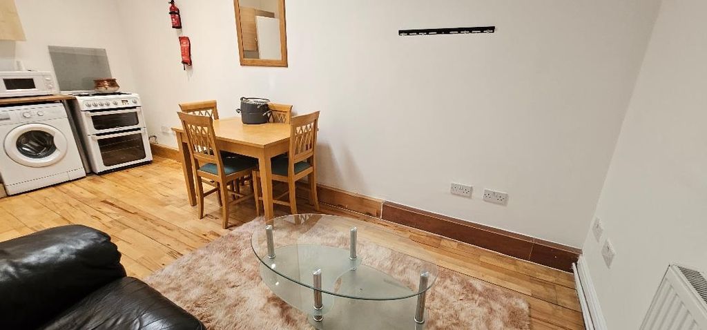 Property photo 3 of 9 A Bright And Inviting Living Room Featuring A Comf...