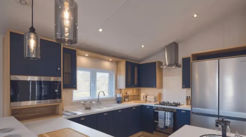 Property photo 2 of 4 Contemporary Navy Kitchen With Integrated Appliances And Breakfast Bar