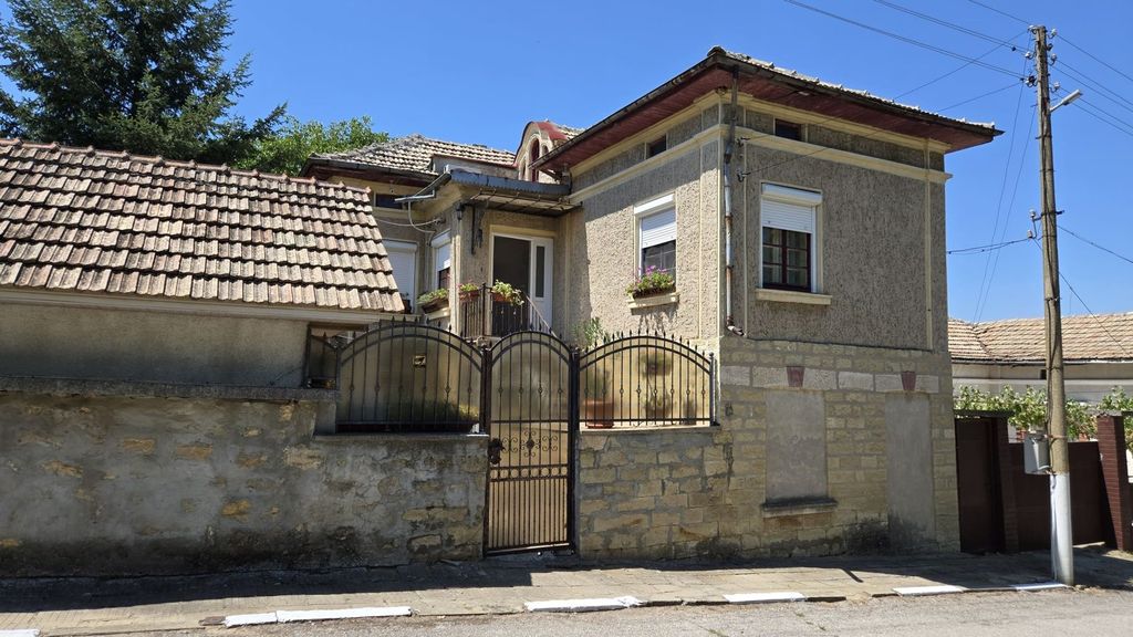 Property photo 1 of 100 Front View Of A Traditional Bulgarian House With A Tiled Roof, Stone Wall, And Metal Gate.