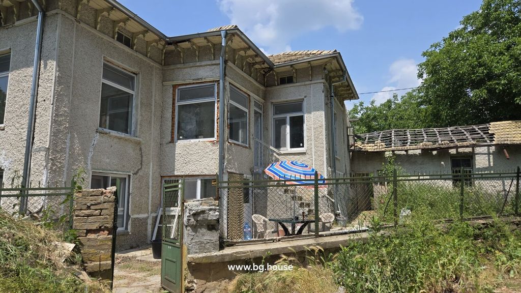 Property photo 3 of 40 View Of The Bulgarian House From A Different Side Angle Showing The Textured Walls, Multiple Windows, And Fenced Yard With Outdoor Seating