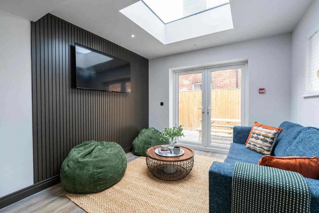 Property photo 1 of 37 A Modern, Well-Lit Living Room Featuring A Large B...