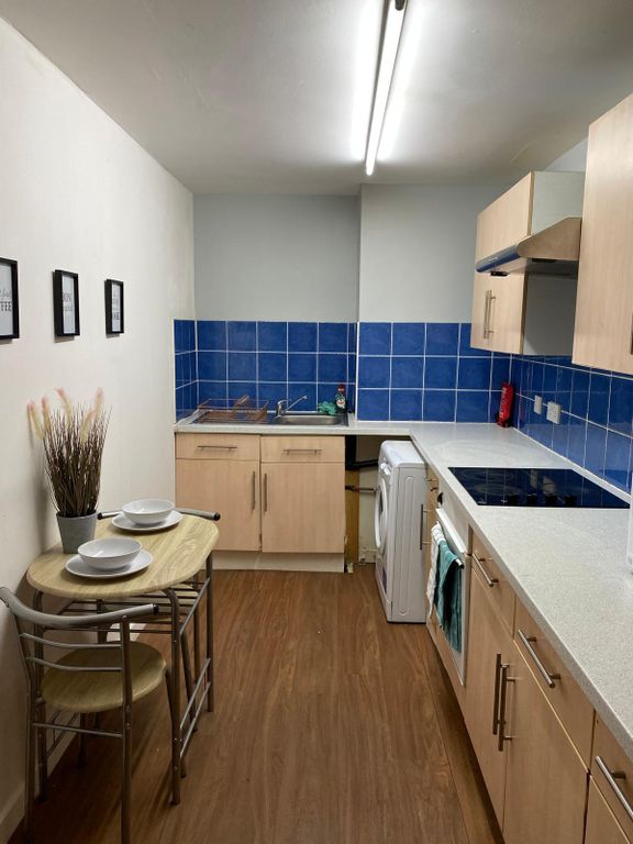 Property photo 2 of 5 This Modern Kitchen Features A Stylish Design With...