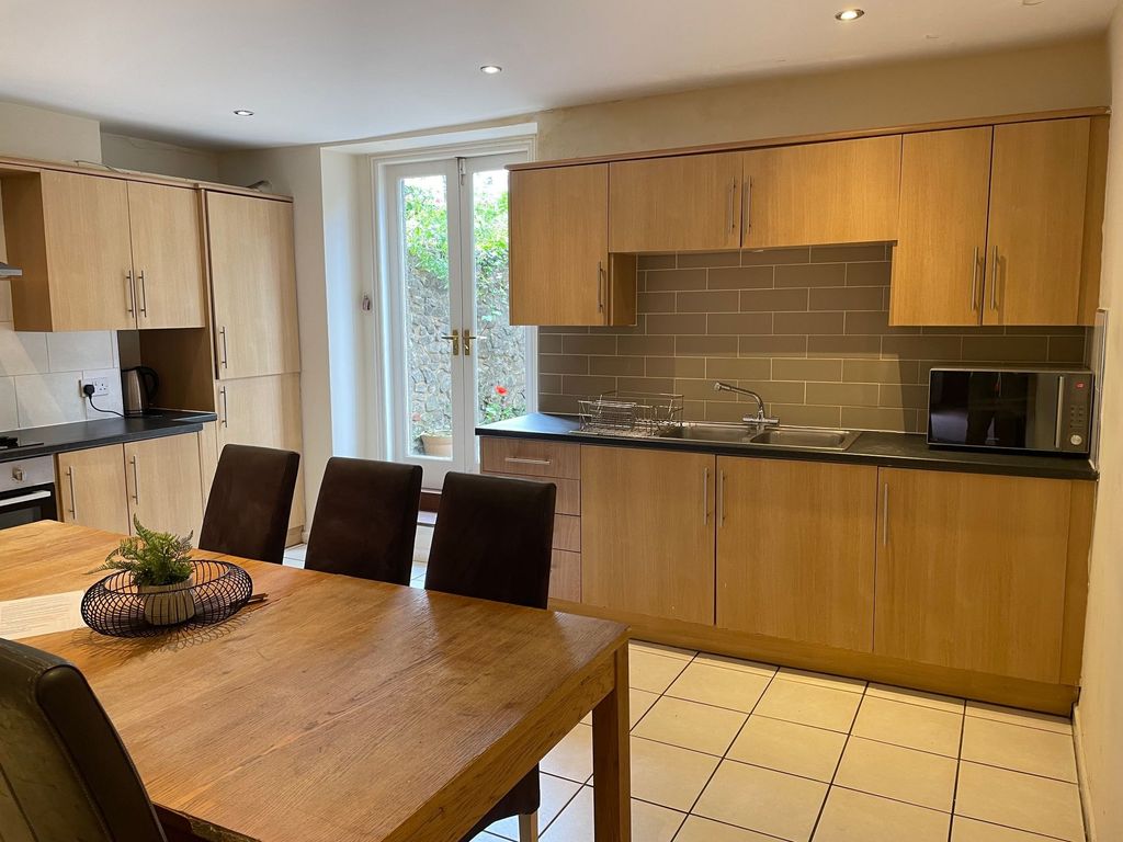 Property photo 3 of 6 Modern Eat-In Kitchen With A Large Wooden Dining T...