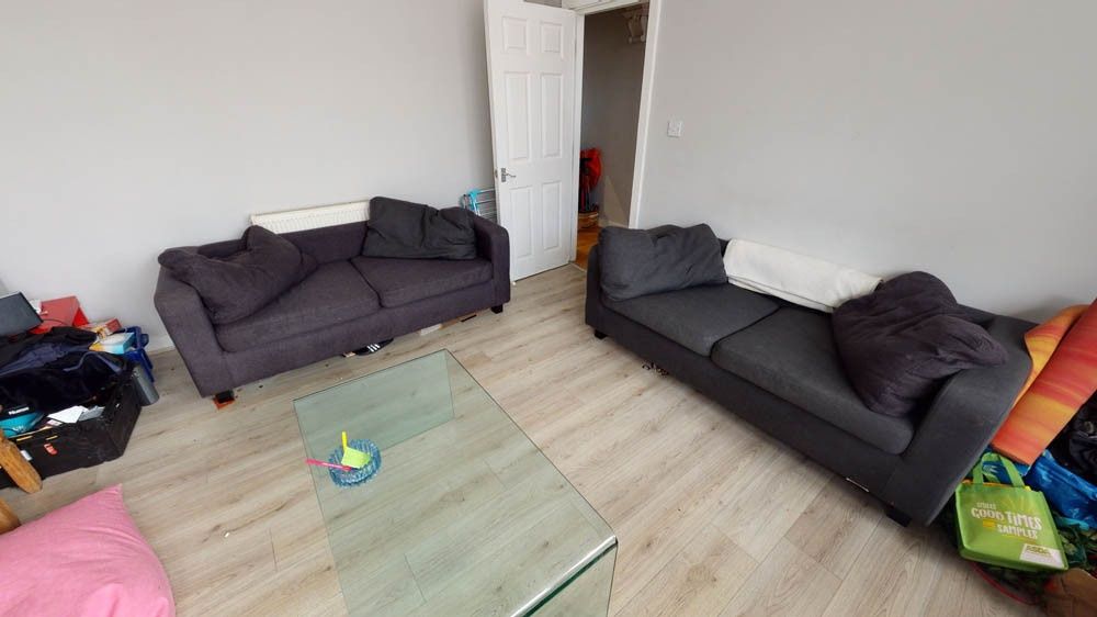 Property photo 2 of 29 Spacious And Well-Lit Living Room Featuring Two Co...