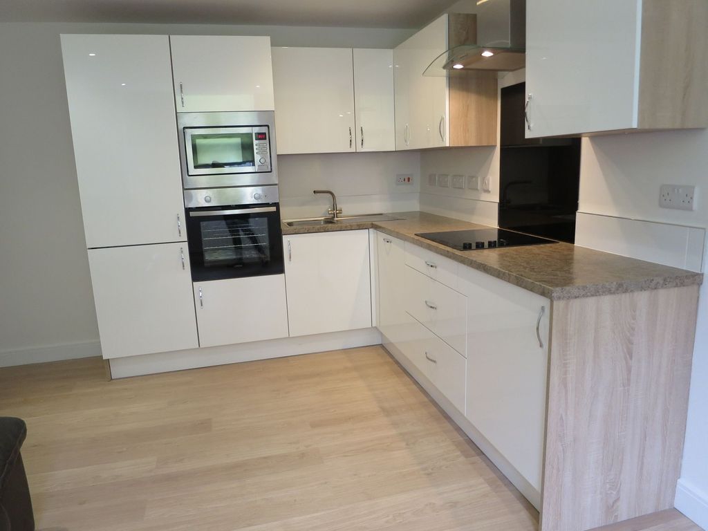 Property photo 2 of 11 Modern Kitchen Featuring Sleek White Cabinetry, A ...