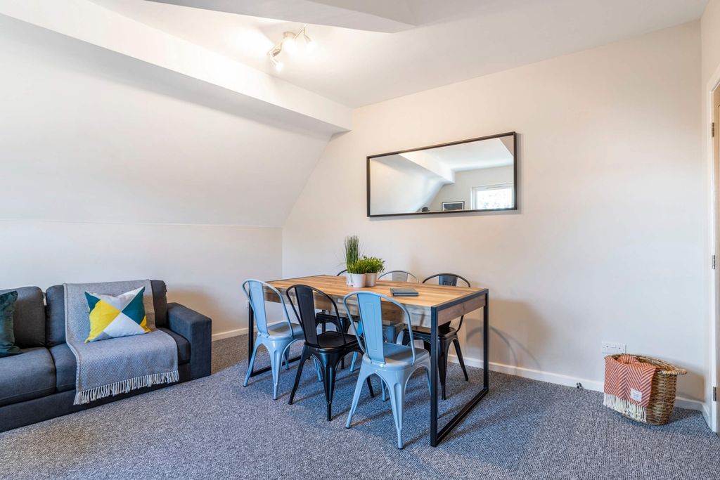 Property photo 2 of 17 A Bright And Inviting Living Room Featuring Modern...