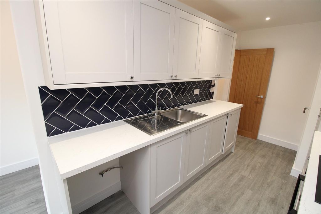 Property photo 3 of 20 Modern Kitchen With Stylish Navy Tiled Splashback...