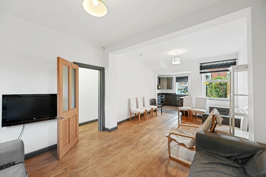 Property photo 3 of 14 A Bright And Inviting Living Room Featuring Modern...