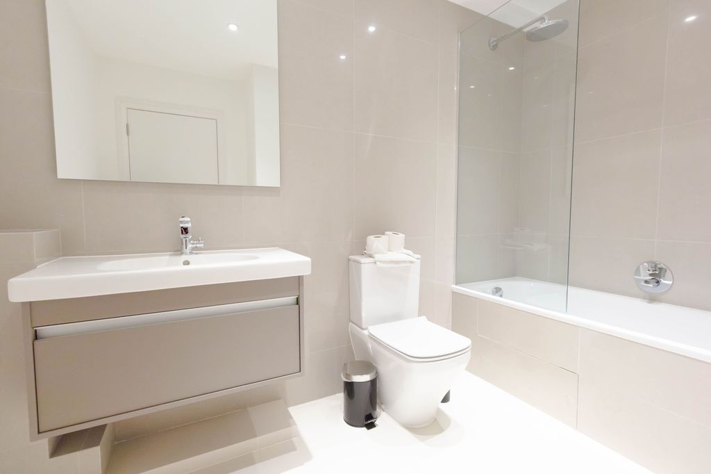 Property photo 2 of 9 A Modern And Pristine Bathroom Featuring A Sleek d...
