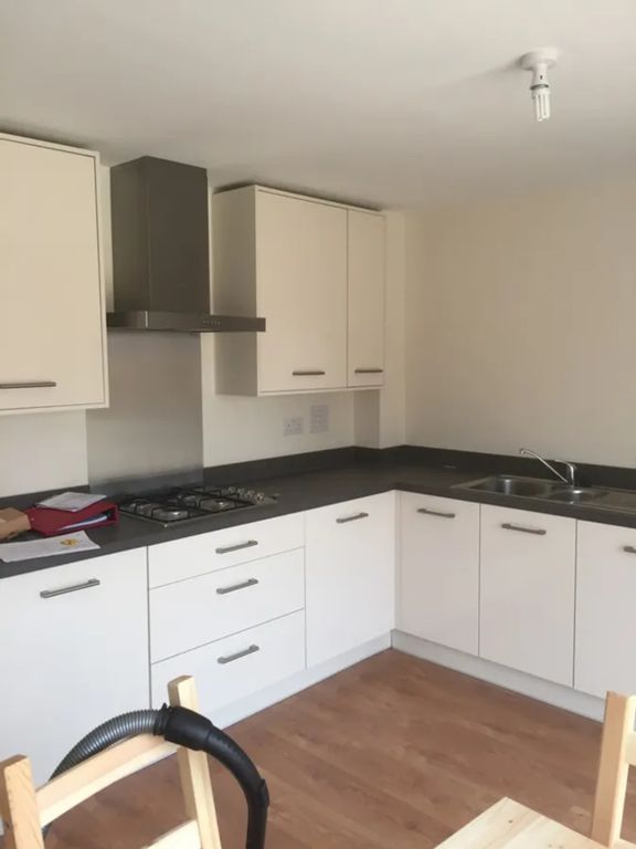 Property photo 1 of 8 Modern Kitchen Featuring Sleek Cabinetry, Ample Co...