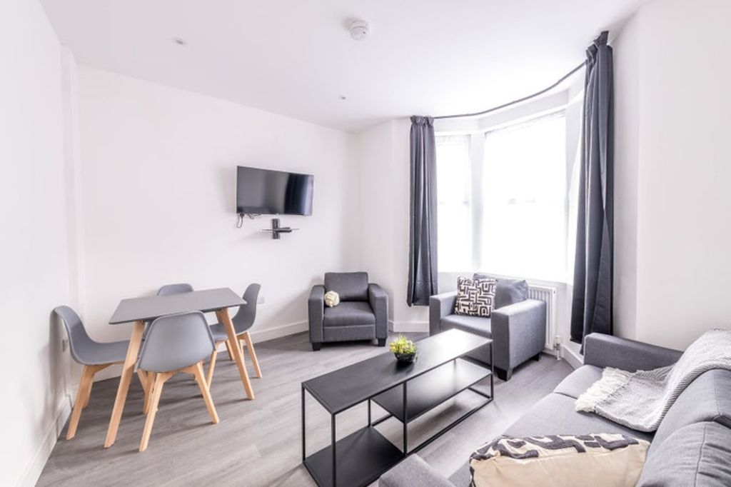 Property photo 1 of 6 Bright And Modern Living Room Featuring Stylish Fu...