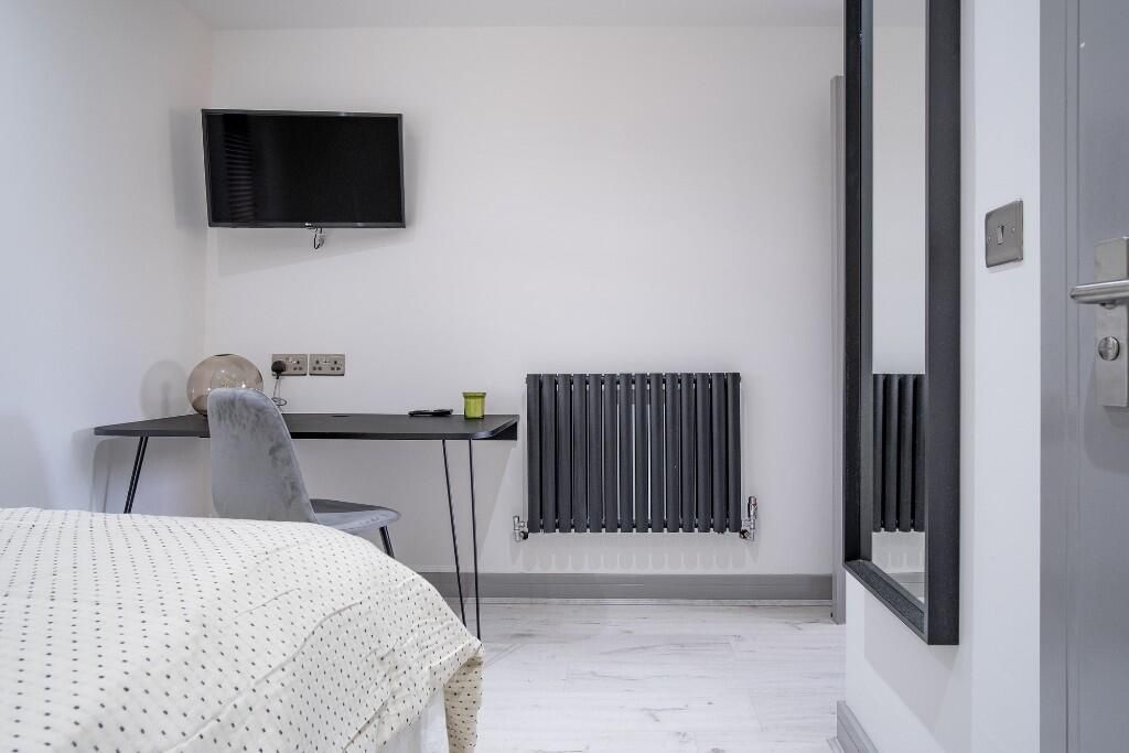 Property photo 3 of 13 A Modern Bedroom Featuring A Comfortable Bed, A Sl...