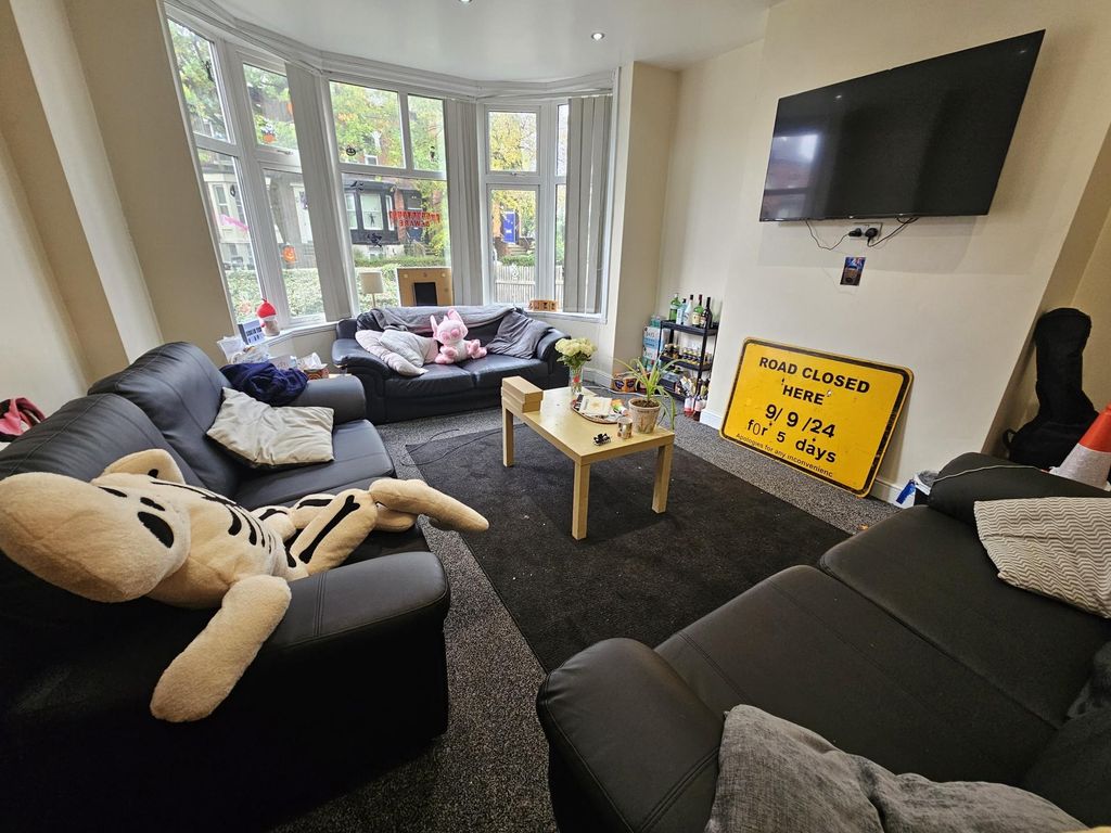 Property photo 2 of 29 Bright And Spacious Living Room Featuring Comforta...