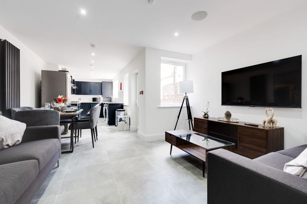 Property photo 1 of 5 Bright And Modern Living Room Featuring Ample Natu...