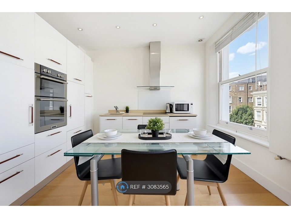 Property photo 1 of 12 Sleek White Kitchen &amp; Dining Space