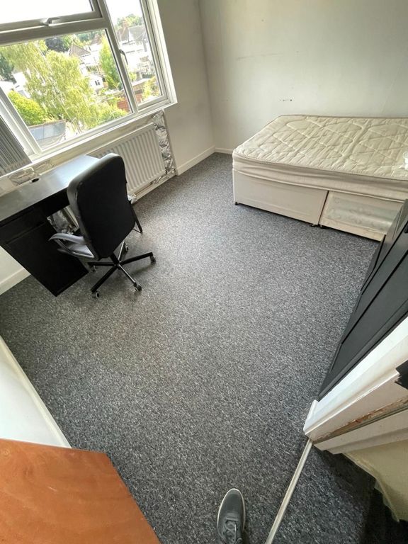 Property photo 3 of 7 Cozy Double Bedroom Featuring A Practical Desk And...