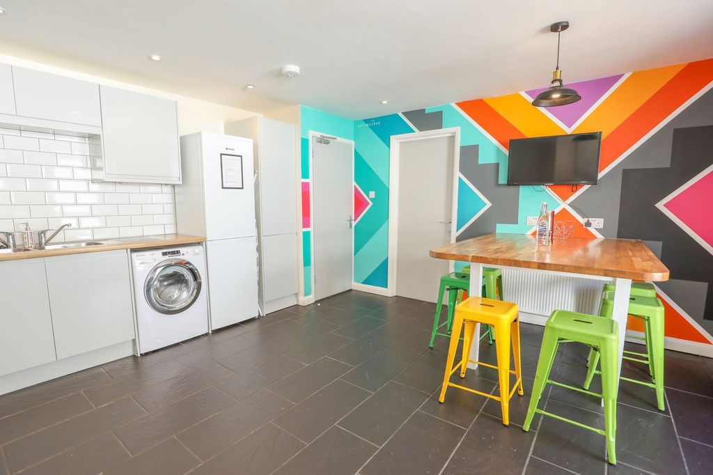 Property photo 2 of 4 This Vibrant Kitchen Features A Modern Design With...