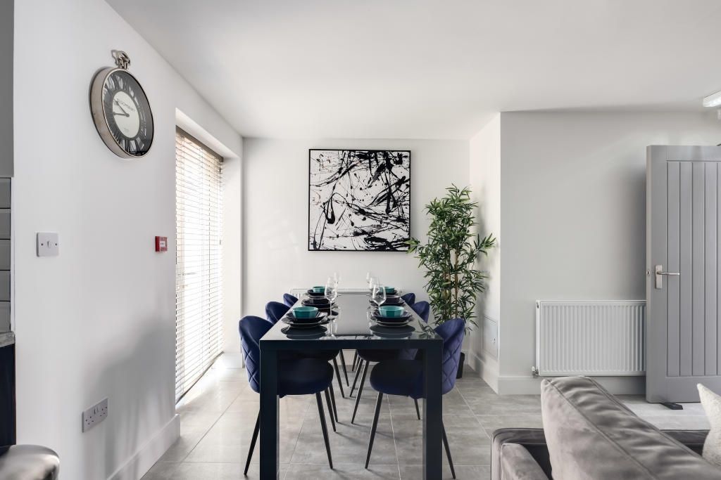 Property photo 2 of 13 Bright And Modern Living Room Featuring A Large Wi...