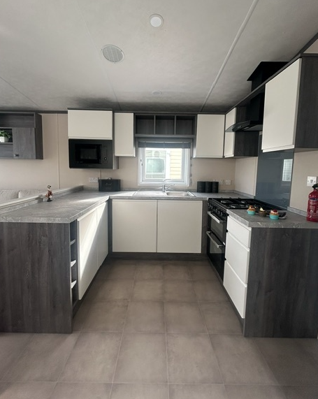Property photo 2 of 3 Modern U Shaped Kitchen With White Cabinets And Grey Worktops In The Pemberton Avon