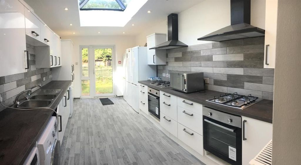 Property photo 2 of 15 Long Galley-Style Kitchen With Modern White Cabine...
