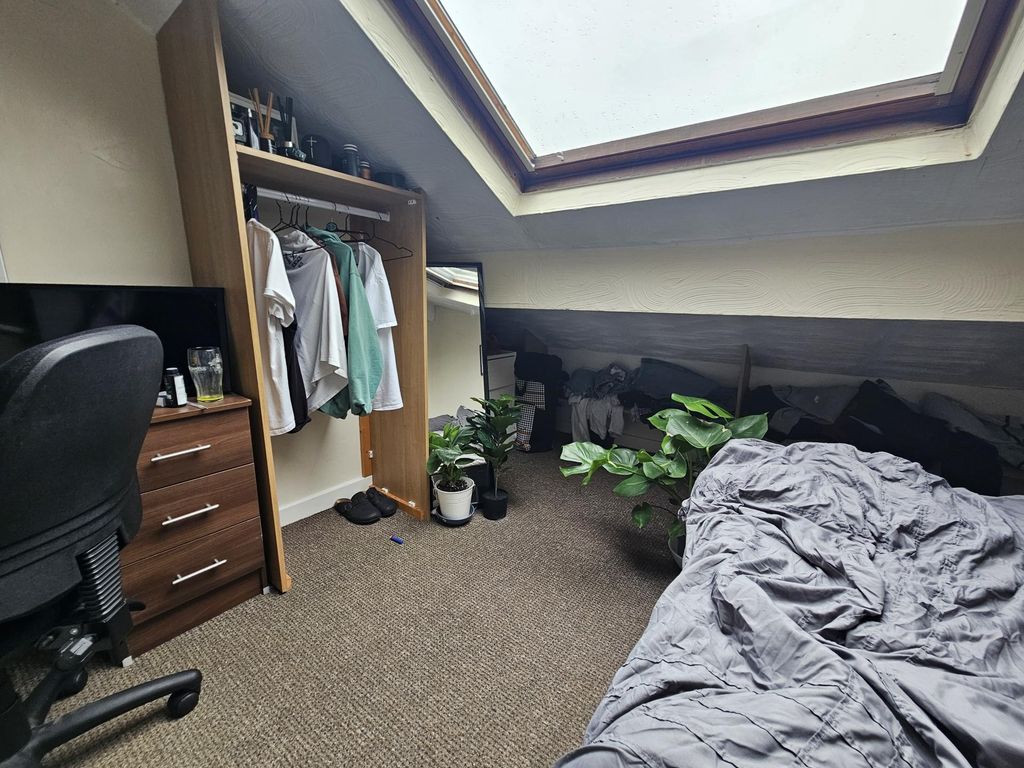 Property photo 2 of 18 A Bright And Cozy Bedroom Featuring A Sloped Ceili...