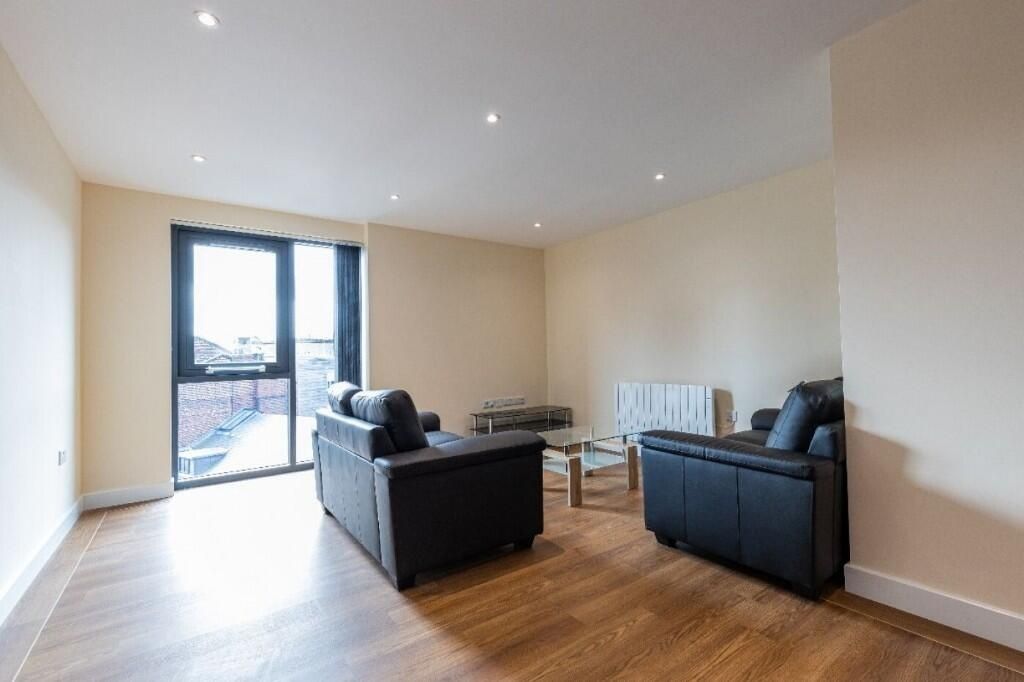 Property photo 3 of 9 A Modern Living Room Featuring Sleek Black Sofas A...