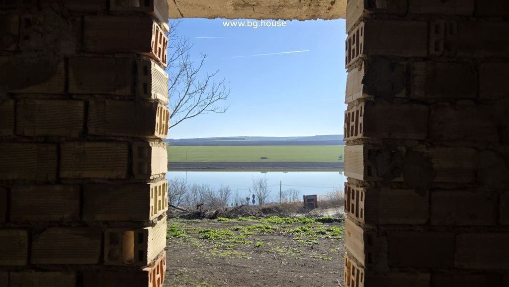 Property photo 1 of 36 View Of Lake And Open Fields Seen Through An Unfinished Brick Wall Opening In The Villa.