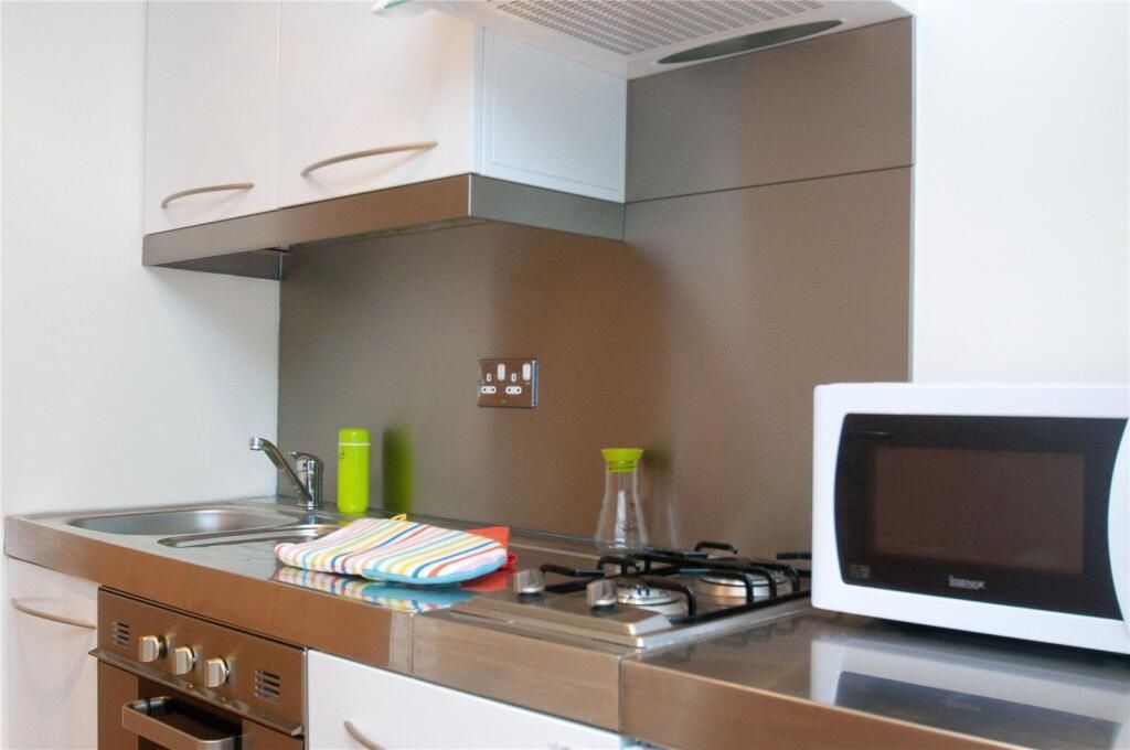 Property photo 2 of 3 Modern Kitchen Area Featuring A Stainless Steel Ov...