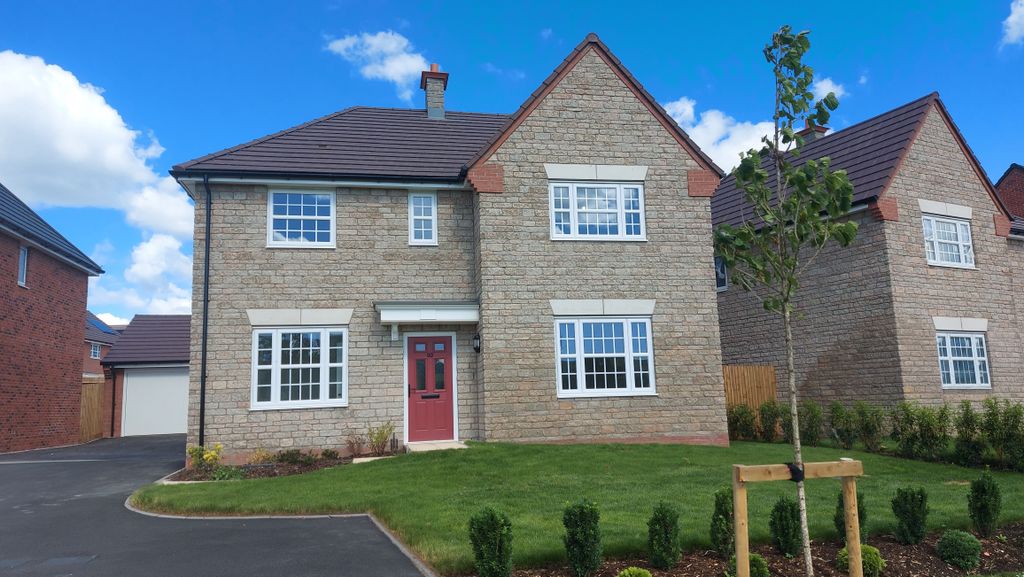 Property photo 1 of 10 A Modern Stone House With A Red Door Sits On A Manicured Lawn In The Foreground