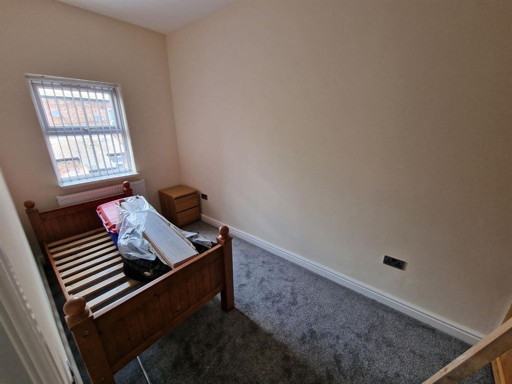 Property photo 1 of 7 Cozy Single Bedroom Featuring A Wooden Bed Frame A...