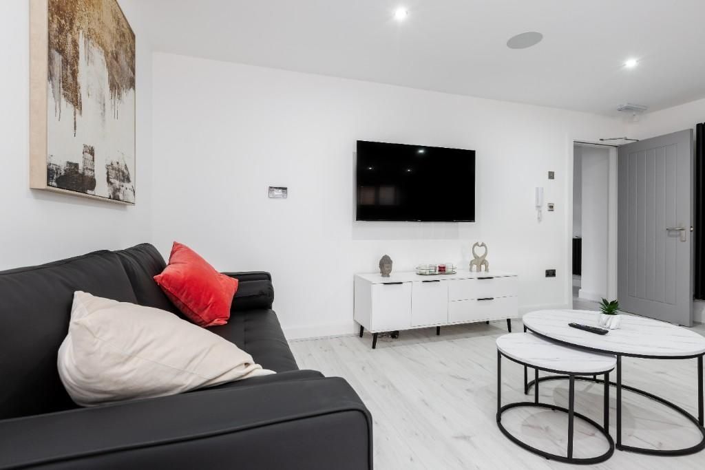 Property photo 3 of 15 A Modern, Well-Lit Living Room Featuring Contempor...