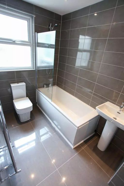 Property photo 2 of 8 A Modern, Well-Maintained Bathroom Featuring Sleek...