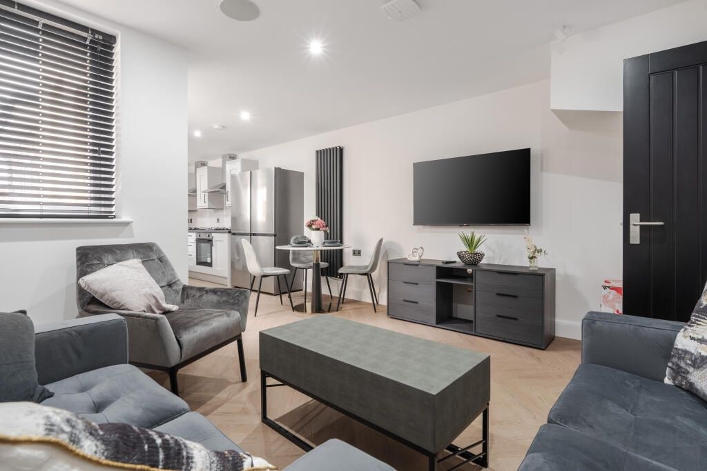 Property photo 2 of 13 A Modern, Spacious Living Room Featuring Stylish F...