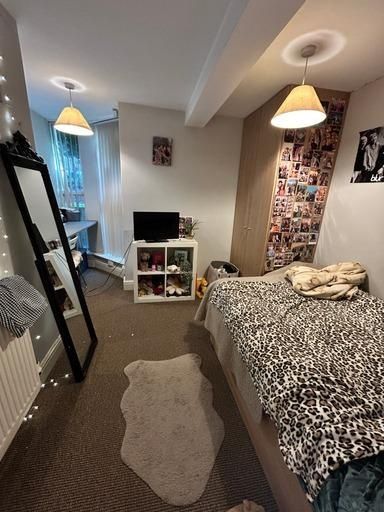 Property photo 2 of 13 A Cozy, Well-Lit Living Room With A Comfortable Be...