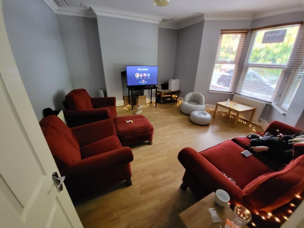 Property photo 3 of 11 A Spacious And Inviting Living Room Featuring Comf...