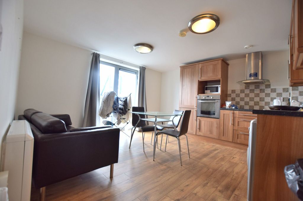 Property photo 1 of 7 Bright And Cozy Living Space Featuring A Modern Ki...